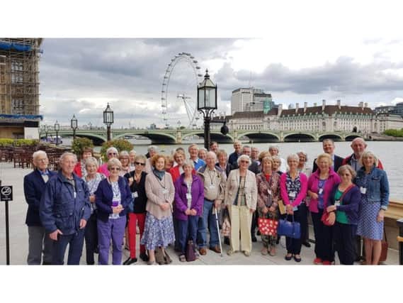 The U3A members by the Thames outside the Houses of Parliament