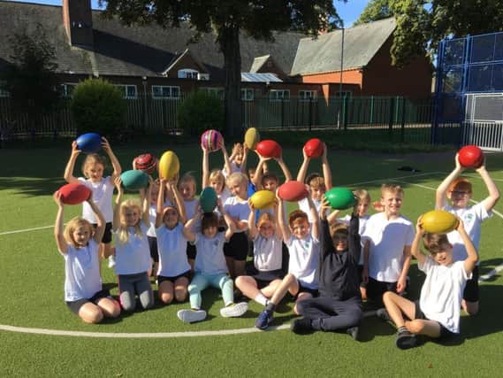 Year 4 kids at Little Bowden Primary School with donated rugger balls