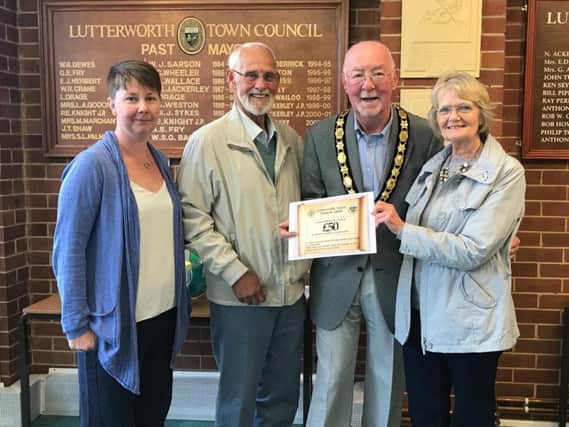 Mr and Mrs Wasik receiving their voucher from Cllr Tony Hirons, accompanied by Clare Morris a member of the Lutterworth Retail Forum.