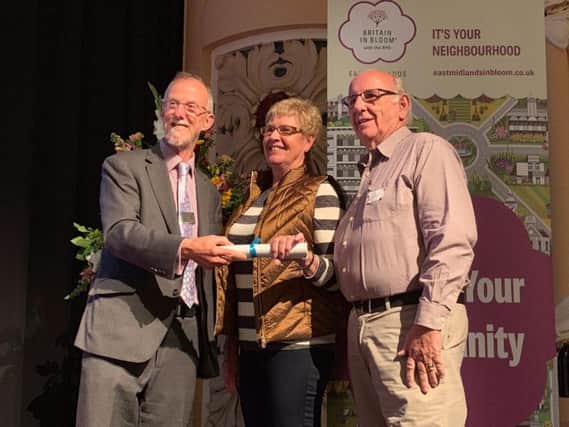 Barbara Tallis (Chair) and Alex Scott (Youth co-ordinator) from Mkt Harborough in Bloom receiving gold medal from president of East Midlands in Bloom Jeff Bates.