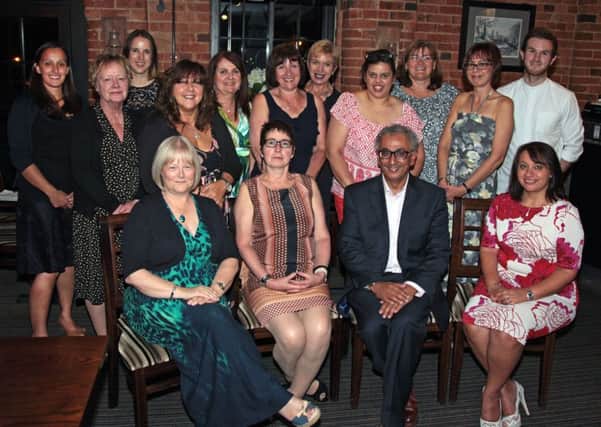 Sad farewell...centre, Dr Jane Taylor with Dr Vipul Masharani and all the practice staff at the Masharani Surgery in Lutterworth.