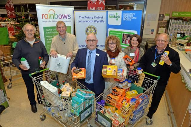 Boost...Geoff Cobbe and Nigel Bones president of The Rotary Club of Lutterworth Wycliffe, Mark Kiely waitrose store manager, Lyn Martin project manager, Stephanie Heath and John Warren chairman of Lutterworth Food Bank after the trolley dash.
PICTURE: ANDREW CARPENTER