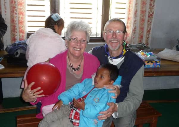 Anne and Charles Barton with one of the children at the Hope Centre in Nepal