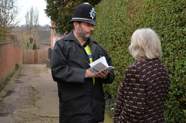 Police speak to the public at the scene of the purse snatch on Symington's Way alley way to Symington's recreation ground.
PICTURE: ANDREW CARPENTER