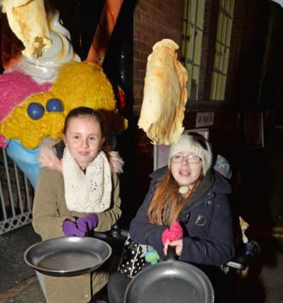 Bethany Wilding 10 and Madi Brooks 11 have a go at tossing pancakes before the start of Race Harborough's one mile run to celebrate pancake day in aid of Madi Wishes for Wheels Appeal.
PICTURE: ANDREW CARPENTER