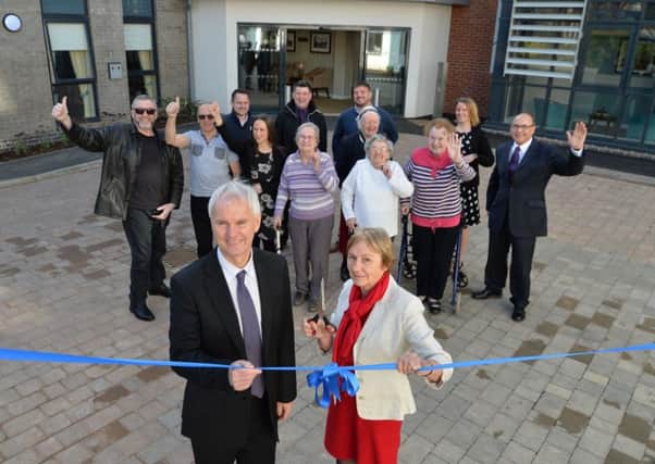 Chair of Acclaim Housing Groups board Janet Ford (front right) officially opens Brooklands Gardens, with Acclaim Housing Groups chief  executive Gerald Taylor (front left), residents of Brooklands Gardens and staff from Seven Locks Housing and Boras Construction.
