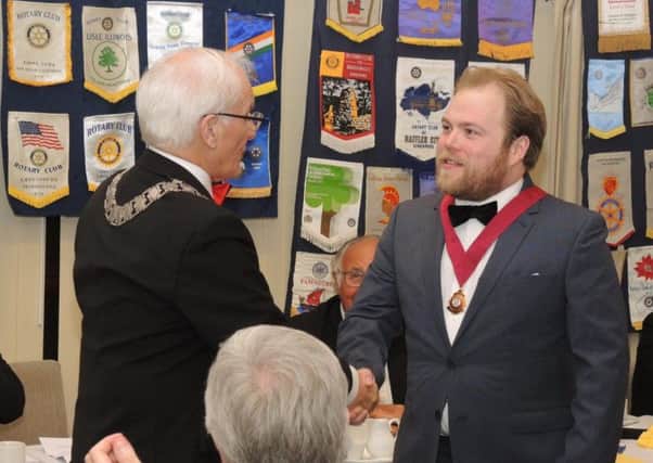 New Rotaract president Chris Wells receives his presidents badge