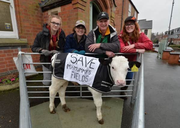 Making a point...Samantha, Julie, Bruce and Abbi Peberdy protesting with a calf outside Great Glen methodist church during a consultancy of developers to the public.
PICTURE: ANDREW CARPENTER