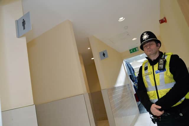 Pc Malcolm Roberts inside the indoor market toilets where racist graffiti messages have been left.
PICTURE: ANDREW CARPENTER