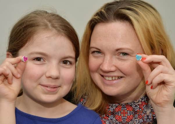 Keeley Pearl and daughter Poppy who both had meningitis are raising funds with their hand made heart pins.
PICTURE: ANDREW CARPENTER