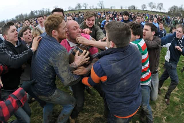 Dave Marlow of Hallaton holds onto the barrel. (MHMP Mail Picture: Andrew Carpenter/001609-38) ENGNNL00320130204133404