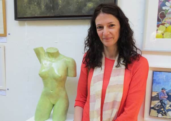 Helen Lopez with her sculpture Eve