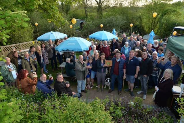 Ship shape....centre, Mary and Tony Matts with daughter Hannah and Son Sam with a plaque celebrating 50 years at Foxton Boat Services with family, friends and work colleagues.PICTURE: ANDREW CARPENTER