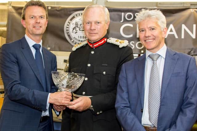 From L-R: William Church, David Laing, and Jonathan Church with the award.