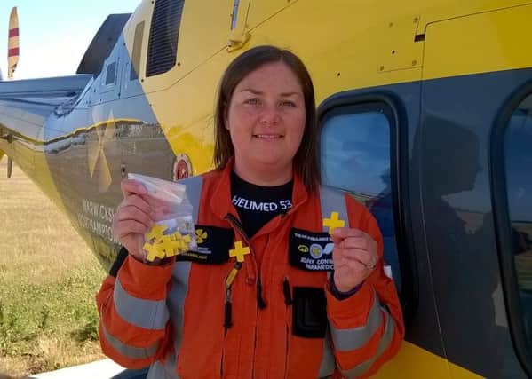 Critical care paramedic Jenny Conway with Air Ambulance Week badges