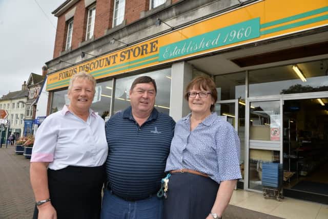 Sad day...owners Linda and Rob Ford with Doreen Woodward who has worked there for 26 years outside Fords Discount Store after 56 years of trading in Lutterworth.
PICTURE: ANDREW CARPENTER