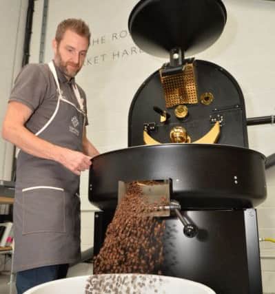 After the coffee beans have been roasted and blended they are emptied from the roastery by Jay Vye.
PICTURE: ANDREW CARPENTER NNL-160926-102819005