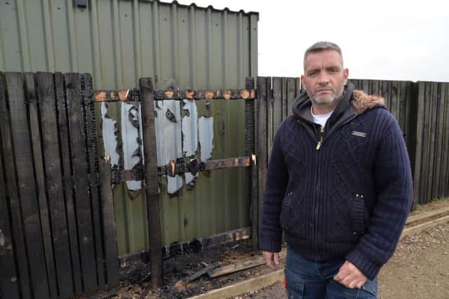 Harborough Town Football Club premises officer Kez Dunkley beside the arson attack at the club.
PICTURE: ANDREW CARPENTER
