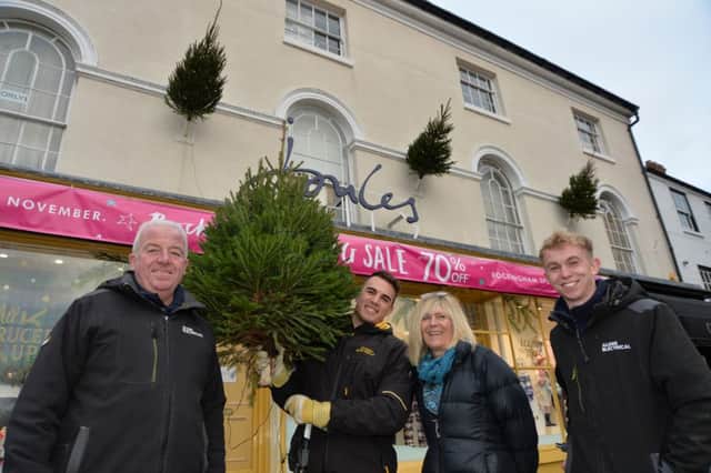 Treemendous...Steve Alden, Ethan Godefroy, Ben Crane and Linda Toszek putting up the christmas trees around the town.
PICTURE: ANDREW CARPENTER