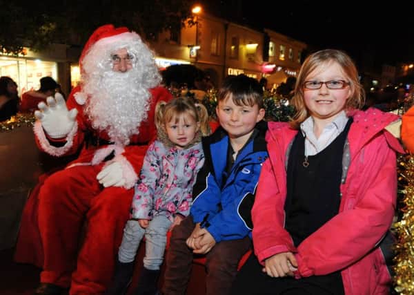 Amelia Grace Arno, Ethan Arno and Felicity Arno meet Santa on the 3rd Market Harborough Scouts float at the Late Night Shopping event last year. (Mail picture: Andrew Carpenter/MHMP001661-13) NNL-140611-164749001