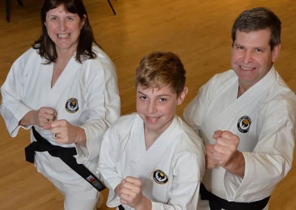 Family affair...Debbie, Tom (13) and Mark Barber have all just gained their black belt in karate.
PICTURE: ANDREW CARPENTER