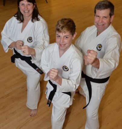 Family affair...Debbie, Tom (13) and Mark Barber have all just gained their black belt in karate.
PICTURE: ANDREW CARPENTER