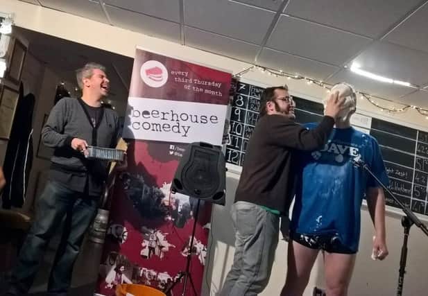 Ivan Sheldrake delivers a custard pie into Dave Hall's face during the comedy night at the Beerhouse.