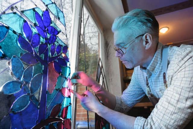 Derek Hunt working on a stained glass window in his studio at Medbourne.
PICTURE: ANDREW CARPENTER