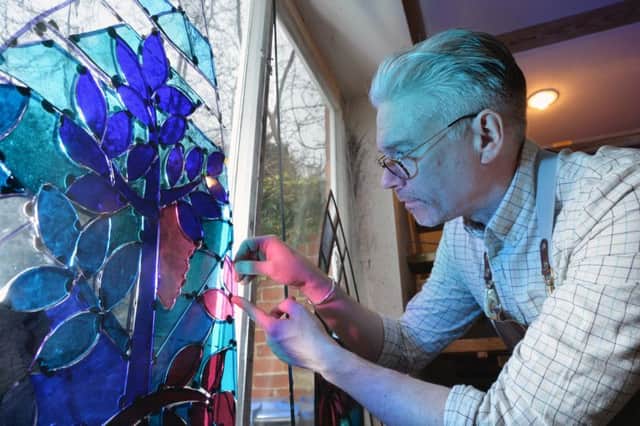 Derek Hunt working on a stained glass window in his studio at Medbourne.
PICTURE: ANDREW CARPENTER
