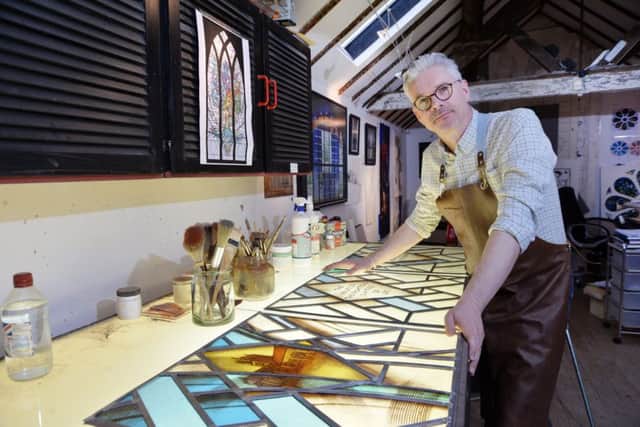 Derek Hunt working on a stained glass window in his studio at Medbourne.
PICTURE: ANDREW CARPENTER