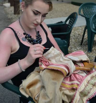 Jade Digweed repairs a costume.
PICTURE: ANDREW CARPENTER