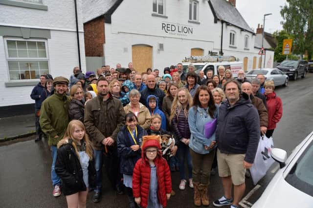 Great Bowden residents and supporters gather outside the Red Lion to gather signatures for a petition to reopen the pub.
PICTURE: ANDREW CARPENTER